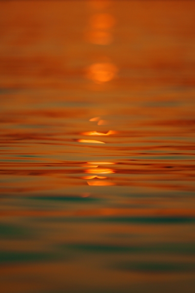 Sunset light plays over a calm sea