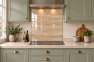 Warm Beige Travertine Effect Glass Splashback as a hob-width panel in a sage shaker kitchen