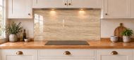 Warm Beige Travertine Effect Glass Splashback as a wide panel under the cooker hood in a white shaker kitchen
