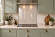 Soft Greige Limestone Effect Glass Splashback as a hob-width panel in a sage shaker kitchen