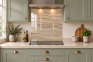 Sandstone Ripple Effect Glass Splashback as a hob-width panel in a sage shaker kitchen