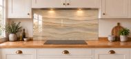 Sandstone Ripple Effect Glass Splashback as a wide panel under the cooker hood in a white shaker kitchen