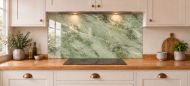 Sage Green Marble Effect Glass Splashback as a wide panel under the cooker hood in a white shaker kitchen
