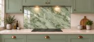 Sage Green Marble Effect Glass Splashback as a wide panel under the cooker hood in a sage shaker kitchen