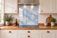 Mist Blue Marble Effect Glass Splashback as a hob-width panel in a white shaker kitchen
