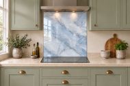 Mist Blue Marble Effect Glass Splashback as a hob-width panel in a sage shaker kitchen