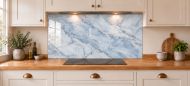 Mist Blue Marble Effect Glass Splashback as a wide panel under the cooker hood in a white shaker kitchen