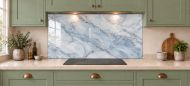 Mist Blue Marble Effect Glass Splashback as a wide panel under the cooker hood in a sage shaker kitchen
