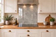 Warm Grey Concrete Effect Glass Splashback as a hob-width panel in a white shaker kitchen