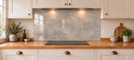 Warm Grey Concrete Effect Glass Splashback as a wide panel under the cooker hood in a white shaker kitchen
