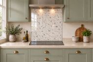 Ivory Terrazzo Effect Glass Splashback as a hob-width panel in a sage shaker kitchen