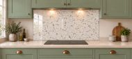 Ivory Terrazzo Effect Glass Splashback as a wide panel under the cooker hood in a sage shaker kitchen